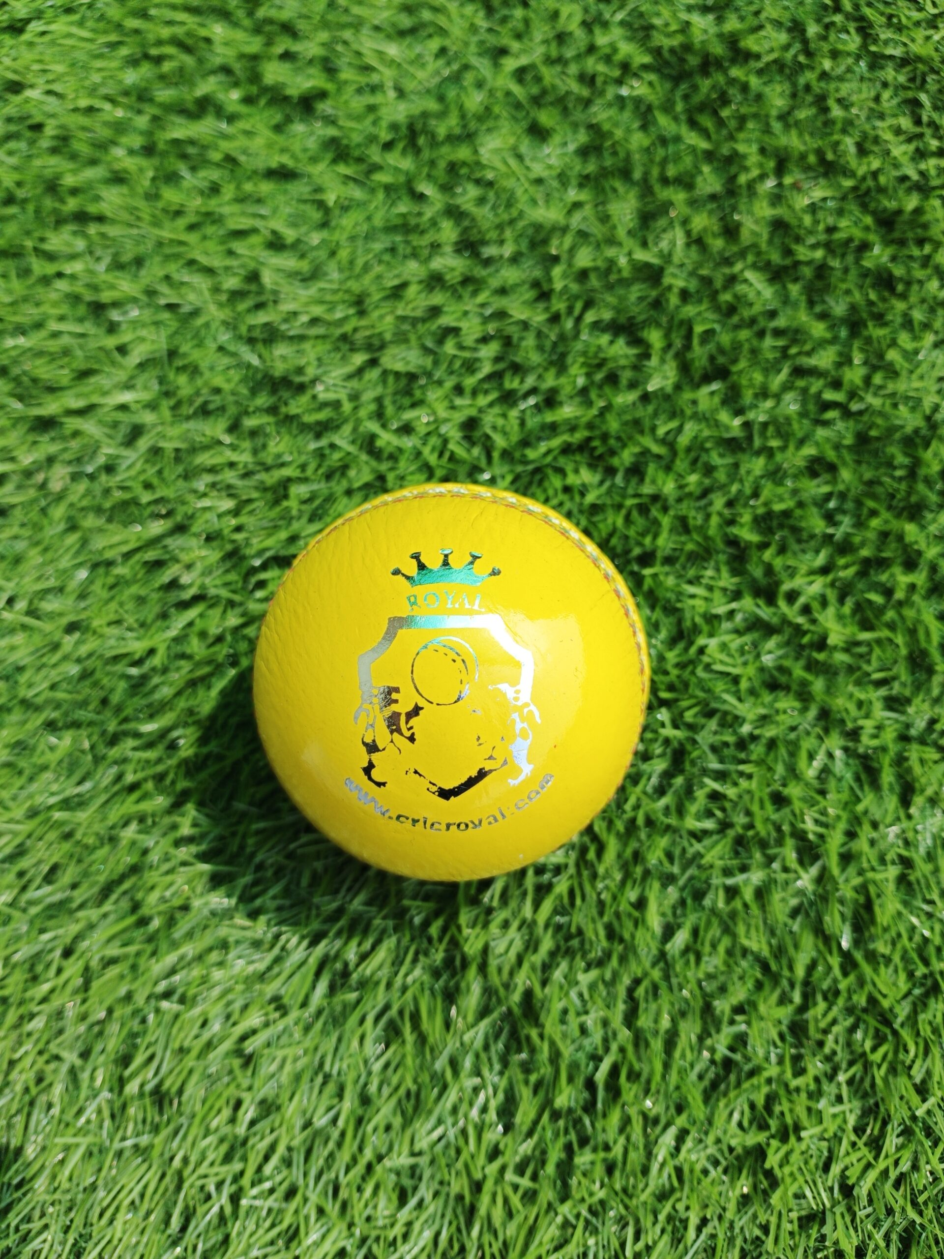Yellow Indoor Premium Leather Cricket Ball shown from front view with Royal Cricket logo on top, designed for high-quality indoor practice with soft yet durable leather surface