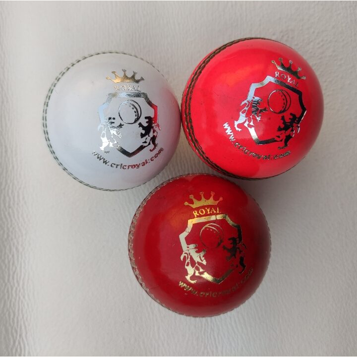 Three leather cricket balls in different colors (red, white, and pink), neatly arranged in front view to showcase variety in color options and high-quality seam detailing.