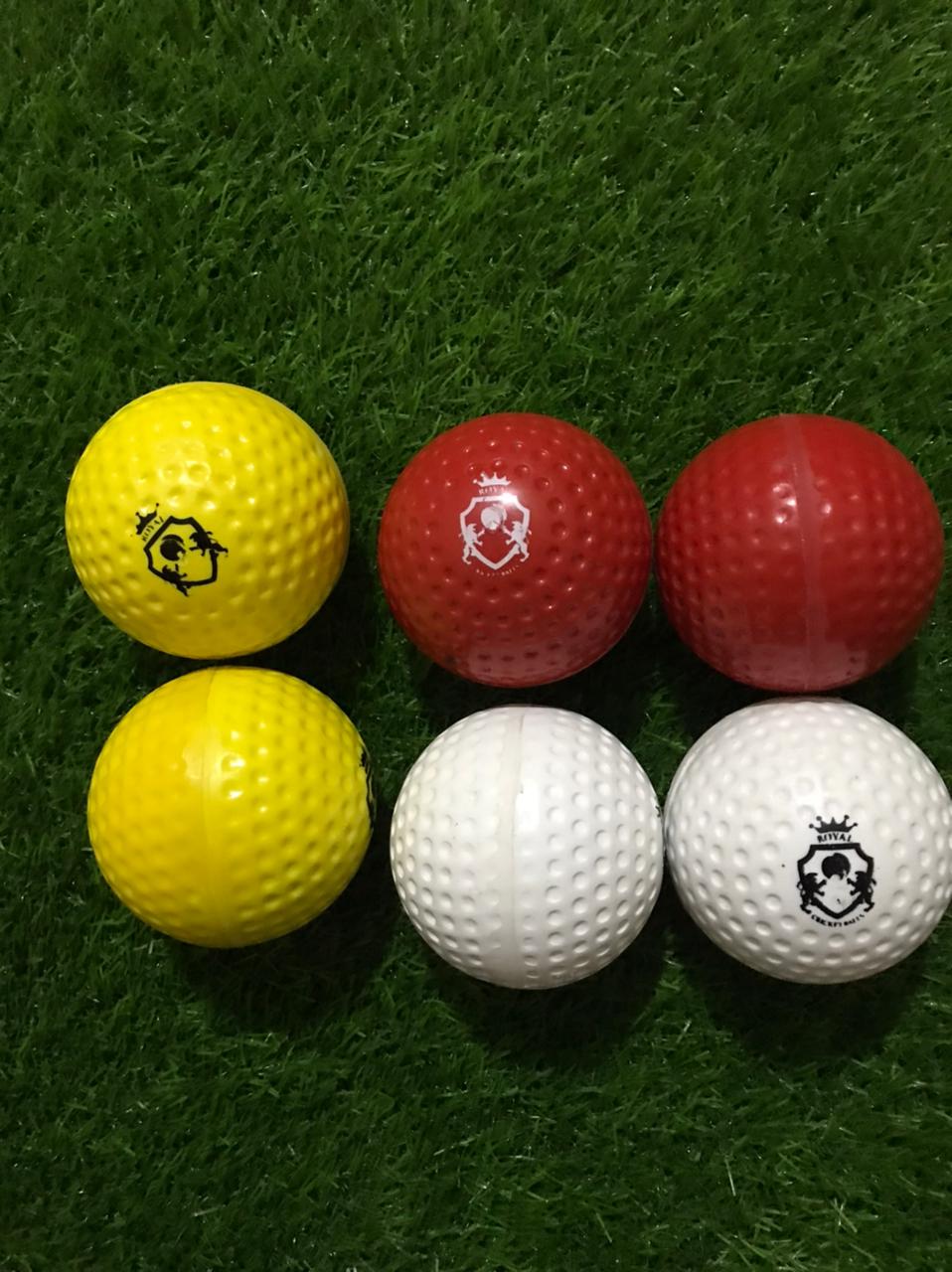 A set of six Dimple Soft Molded Synthetic Cricket Balls in various vibrant colors, displayed on a surface with a mix of front and side views, showcasing the design details and textures from multiple angles.
