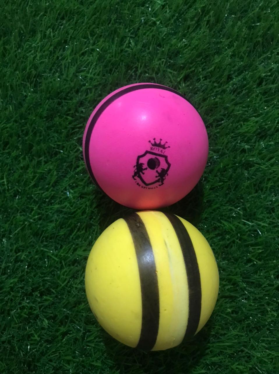 Two plain bowling machine balls in pink and yellow colors; pink ball shown from front with logo, yellow ball placed sideways to highlight shape and structure