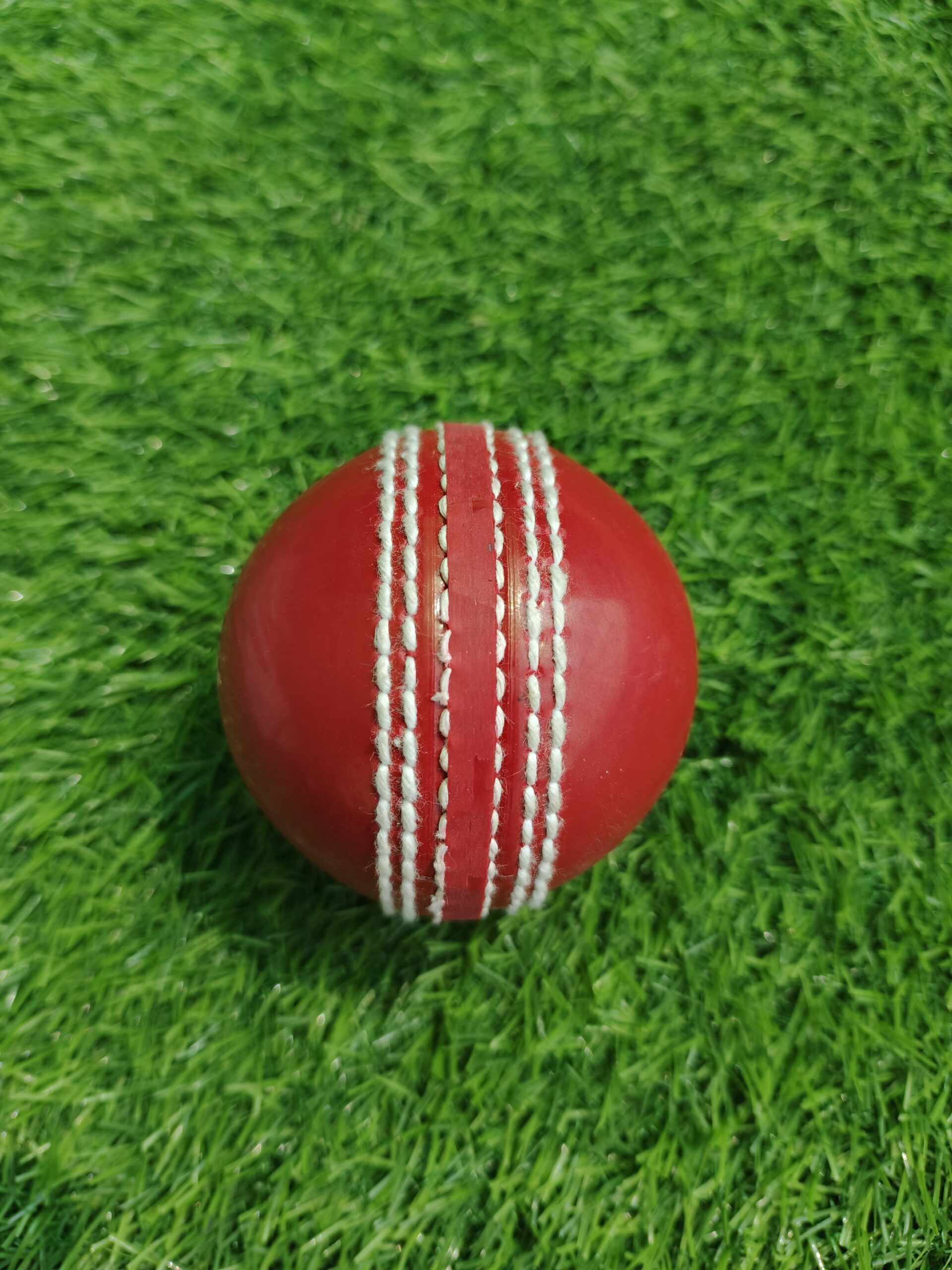 PVC Soft Practice Cricket Ball 5 Red Soft PVC Synthetic Stitched Practice Cricket Ball shown from side view focusing on the stitched seam, highlighting durable build and quality for practice use