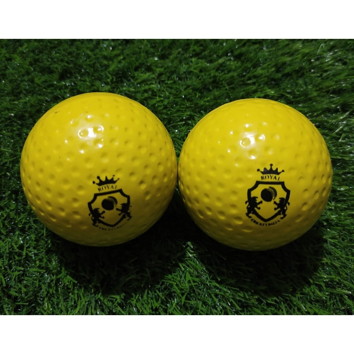 Two yellow Wind Balls placed on grass, both shown from front view with Royal Cricket logo visible, ideal for soft cricket practice and training